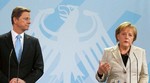 ERMANY AND THE LION'S SHARE German Foreign Minister Guido Westerwelle and Chancellor Angela Merkel; Germany will take the lion's share of patching up the EU economy