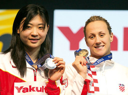 Sanja Jovanovic with the gold medal she won on the 50m backstroke at the World Championships in Manchester; Gao Chang from China took second place