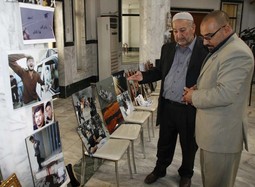 OTAC UBIJENOG
FOTOGRAFA, Husseinn Noor- Eldin razgledava
izložbu sinovih fotografija u Mosulu s posjetiteljem